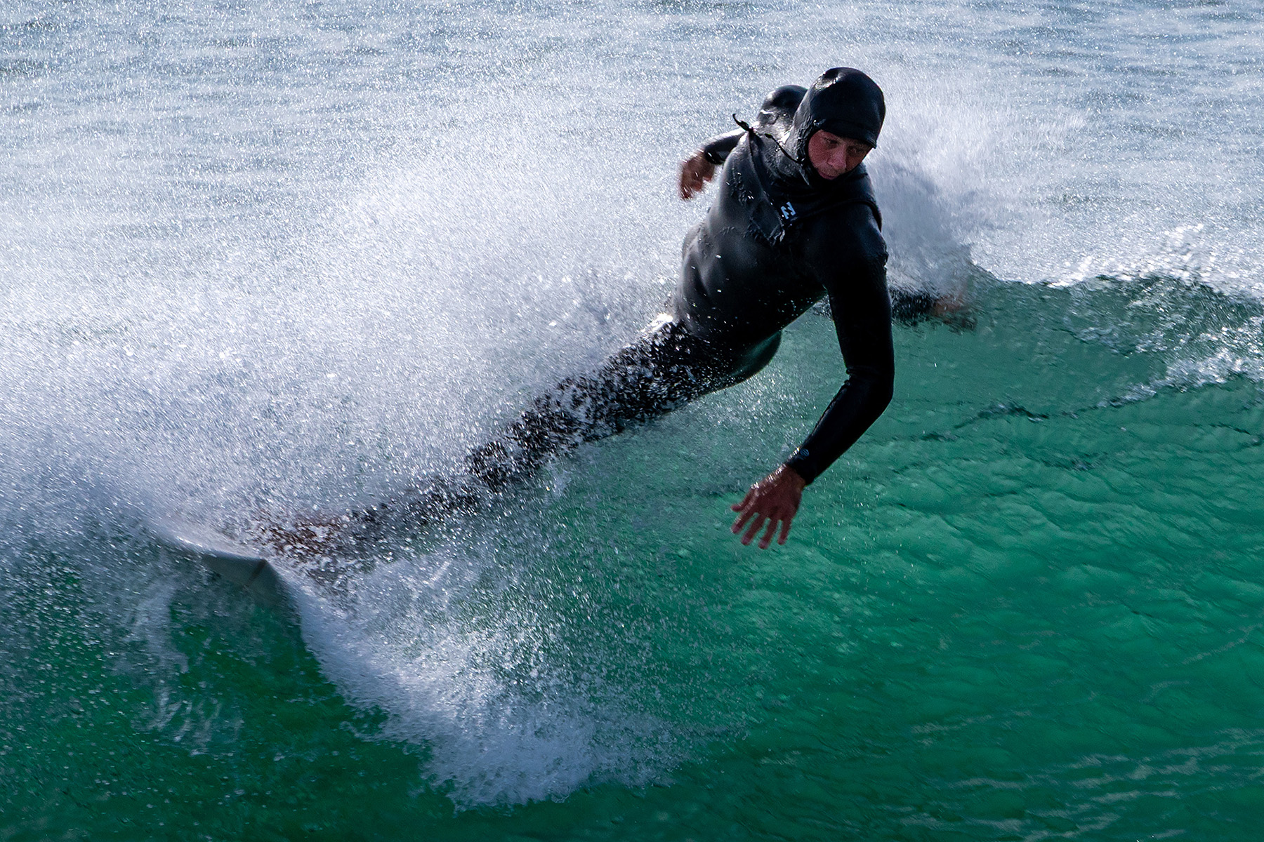 image of a surfer beginning to lose contact with his board