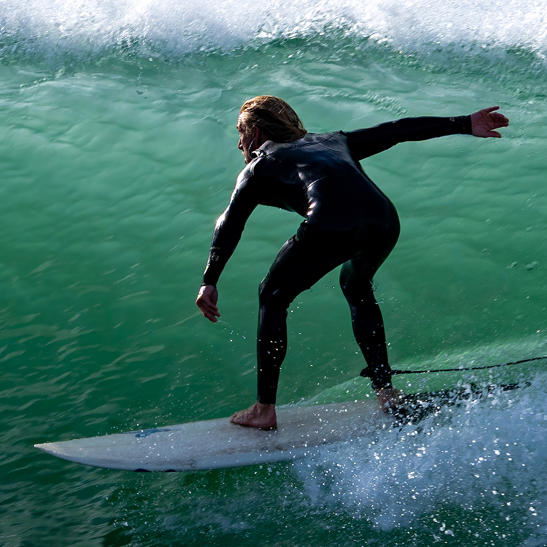 surfer against a wave wall background