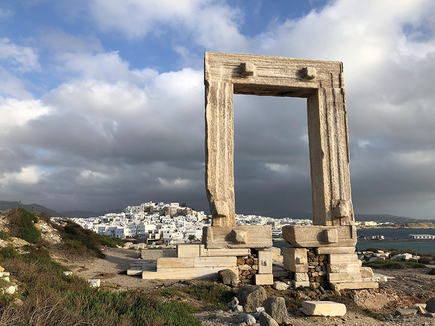 Great ancient arch at the mouth of the harbor in Naxos, Greece