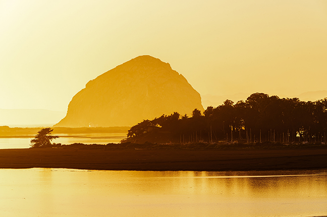 Stylized image of Morro Bay and Morro Rock, in heavily saturated yellow hues.